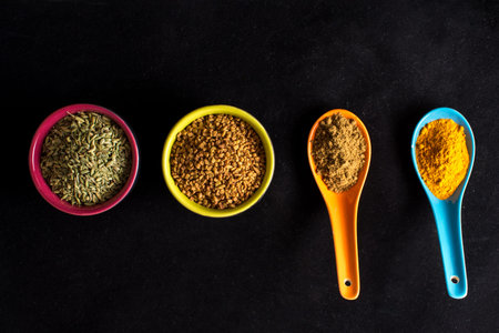 Colorful Indian spices on black background
