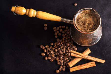 Turkish coffee, with coffee beans and cinnamon on dark backgroundの写真素材