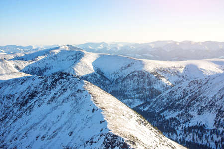 majestic winter landscape of snowy mountains with a clear blue sky in the sunset, the concept of the greatness and beauty of natureの写真素材