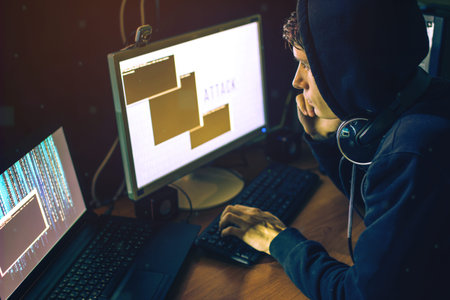 young hacker in the dark breaks the access to steal information and infect computers and systems....