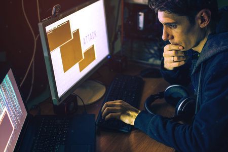young hacker in the dark breaks the access to steal information and infect computers and systems....