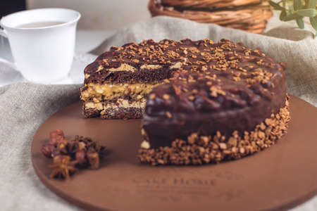 Delicious chocolate layered cake with nougat and sponge cake in the cut on the plateの写真素材