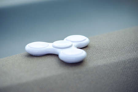 White fidget spinner stress relieving toy. Trends in children's anti-stress toys for attentionの写真素材