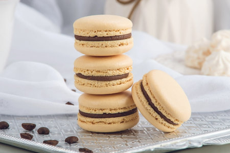 Coffee macarons with chocolate. French delicate dessert for Breakfast in the morning light
