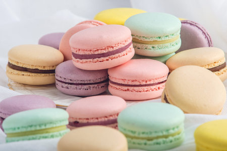 Colorful macarons on a white background. French delicate dessert