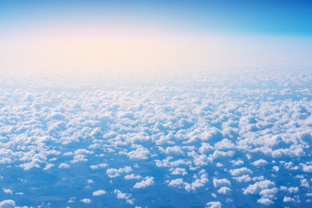Beautiful view of blue sky above the clouds from airplane windowの写真素材