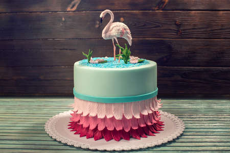 A beautiful cake, decorated with a figure of pink flamingos in the pond. The concept of the Original design of dessertsの写真素材