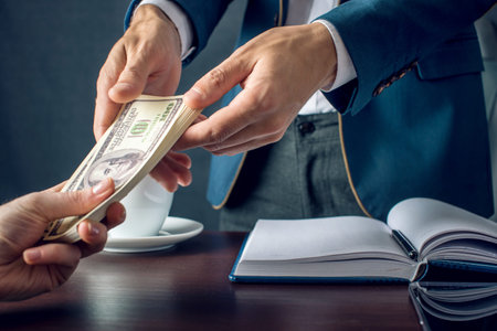 Man Businessman in suit takes the money hands. A bribe in the form of dollar bills. The concept of...