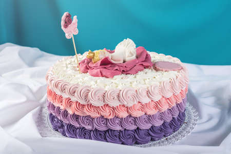 Cute festive pink cake decorated with a big flower where sleeps the little Princess. Candy desserts for a birthdayの写真素材