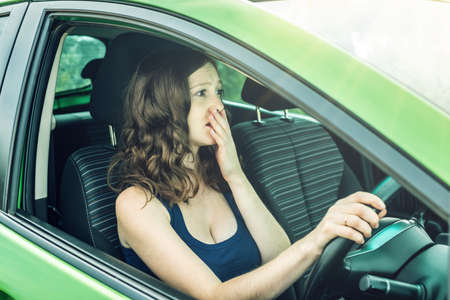 Woman in the car. Hands on the wheel. Focused and tense. The lesson in driving school.の写真素材