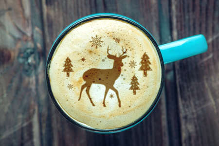 Cute winter pattern in a Cup on the milk foam cappuccino coffee. Christmas moodの写真素材