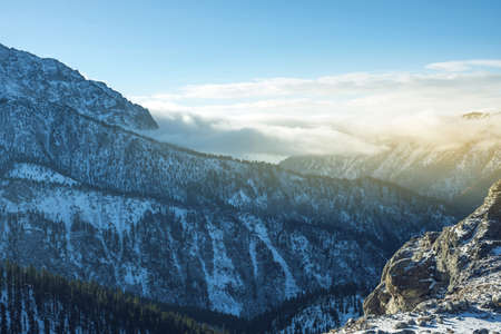 Beautiful view of the mountain peaks of the Baikal mountains in the snow at sunrise. The concept of travel and Hiking tripsの写真素材