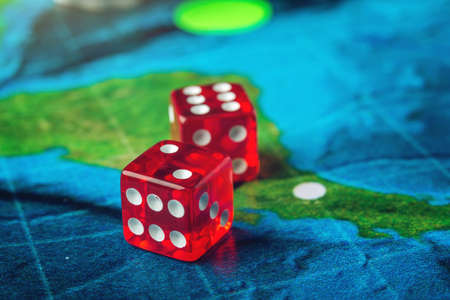 Red playing bones on the world map of the field handmade Board gamesの写真素材