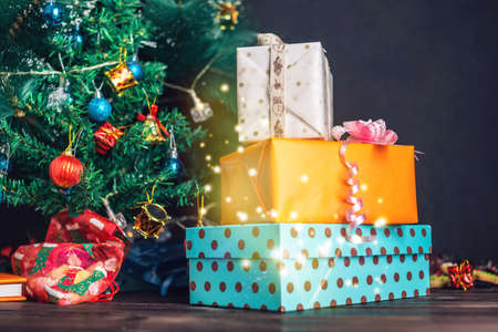 Family gift box from Santa Claus near the Christmas tree on Christmas day. The concept of new year's eve Magicの写真素材