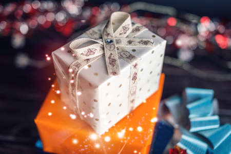 Family gift box from Santa Claus near the Christmas tree on Christmas day. The concept of new year's eve Magicの写真素材