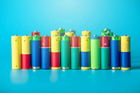 Closeup of a pile of color used alkaline AA batteries. The concept recycling of harmful substances for ecologyの写真素材