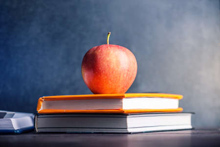 School supplies are on the table. Books and apples is a collection of the student. The concept of school and educationの写真素材
