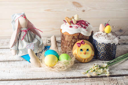 Festive table with cake and colorful eggs on wooden background. The concept of Orthodox Easterの写真素材