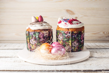 Festive table with cake and colorful eggs on wooden background. The concept of Orthodox Easter