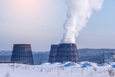 Smoking pipes of thermal power plant emitting carbon dioxide in the form of pillars of smoke in the atmosphere. The concept of environmental pollution and the greenhouse effectの写真素材