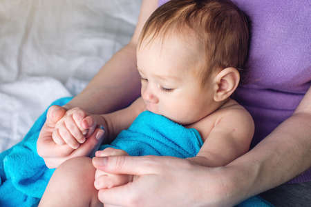Happy caring mother holding baby. The concept of the tenderness of motherhood and family valuesの写真素材