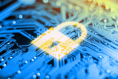 Orange glowing lock icon on the electronic Board with a microchip. Concept of information security technologyの写真素材