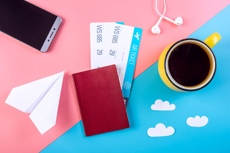 Air tickets with passport and paper plane on pastel background, topview. Bright background. The...
