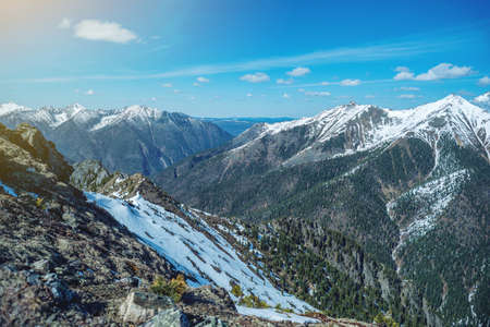 Landscape of snow-capped peaks of the rocky mountains in Sunny weather. The concept of nature and travelの写真素材