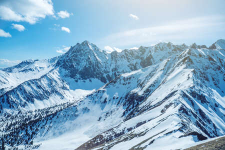 Landscape of snow-capped peaks of the rocky mountains in Sunny weather. The concept of nature and travelの写真素材