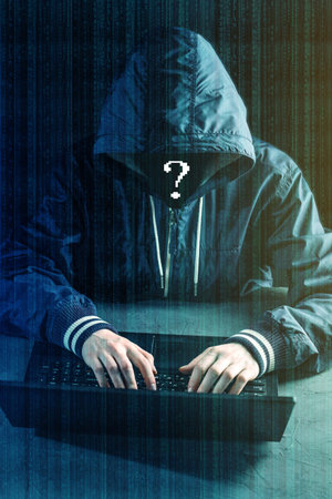 Anonymous hacker programmer uses a laptop to hack the system. Stealing personal data.