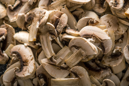 Background of white fresh cut champignons. The concept of cooking mushroom dishes. Close up
