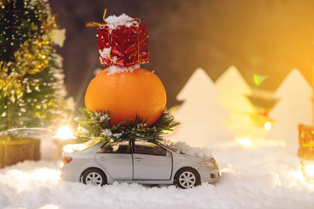 Toy car carries gifts in the Christmas and new year's eve on a blue background. The concept of holiday shopping and discountsの写真素材