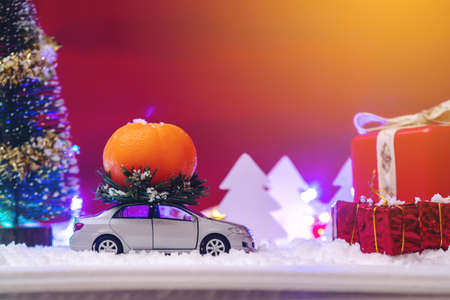 Toy car carries gifts in the Christmas and new year's eve on a blue background. The concept of holiday shopping and discountsの写真素材