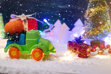Toy car carries gifts in the Christmas and new year's eve on a blue background. Concept of holiday...