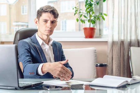 The official businessman sitting at workplace in office refuses bribes. The concept of corruption and briberyの写真素材