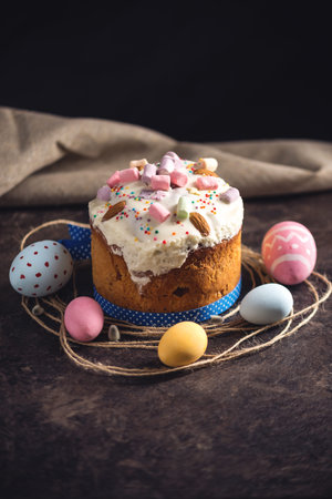 Card with traditional desserts and colorful eggs in rustic style on a dark background. Concept happy...