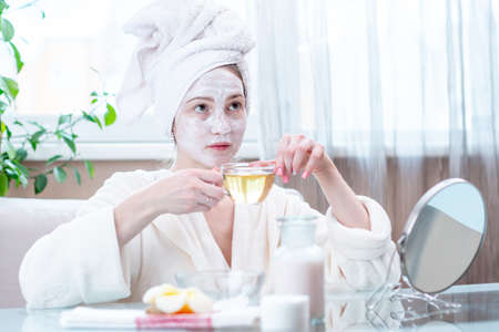 Beautiful happy young woman with natural cosmetic mask on her face. Concept skin care and Spa treatments at homeの写真素材