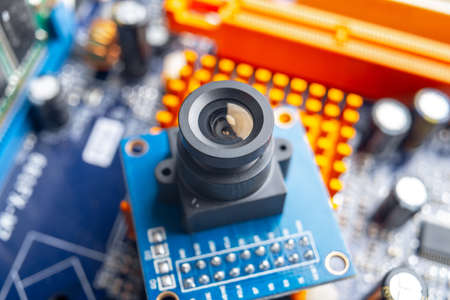 Camera with lens on electronic integrated circuit Board. The concept of high technology and roboticsの写真素材