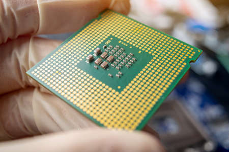 Chip microprocessor in the hands of an engineer technician for the computers. Concept of high technology and repair microchipの写真素材