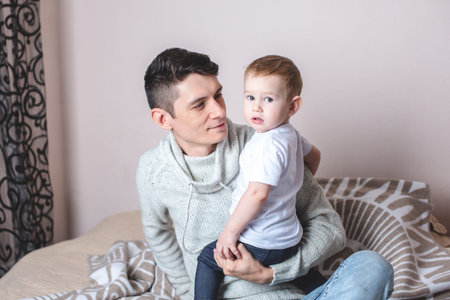 Portrait of father and son's baby. Fatherhood, love and protection of children. Concert of family...
