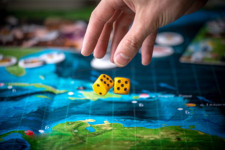 Hand throws two yellow dice on the playing field. Gaming moments in dynamics. Luck and excitement....
