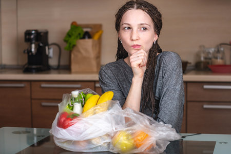 Girl thinks that would refuse to use a plastic bag to buy products in the store. The concept of...