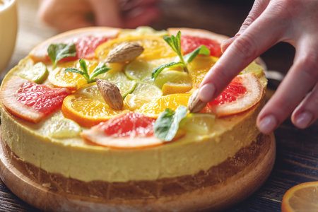 Raw citrus cake with grapefruit, orange, lime and lemon with nuts and mint. Healthy fresh summer dessert. Homemade vegan foodの写真素材