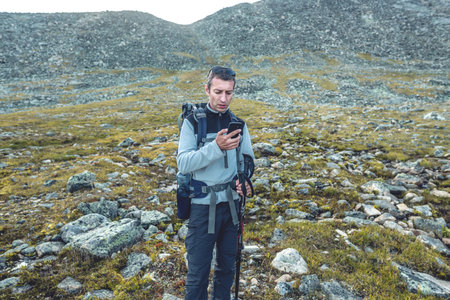 Man hike during the ascent to the peak on the background of a beautiful mountain landscape in the...