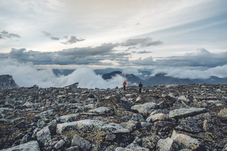 Beautiful view of the mountains from the peak. Landscape with clouds and stones at sunset. The concept of climbing and Hikingの写真素材