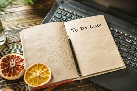 Notepad with open pages and pen on wooden background. Planning goals for the new year on Christmas eve. Space for text. The view from the topの写真素材