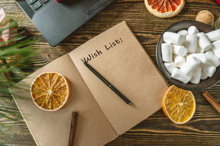 Notepad with open pages and pen on wooden background. Planning goals for the new year on Christmas eve. Space for text. The view from the topの写真素材