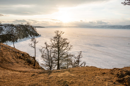 Winter sunset landscape of lake Baikal on Olkhon island. Mountains of snow and ice. Unique nature...