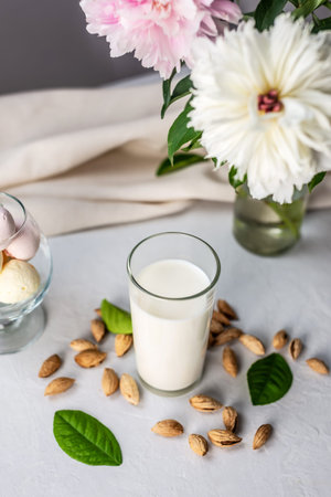 Vegetable natural almond milk on the table. Nutty alternative vegetarian drink for a healthy diet