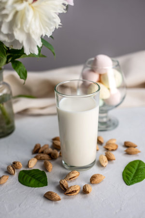 Vegetable natural almond milk on the table. Nutty alternative vegetarian drink for a healthy diet